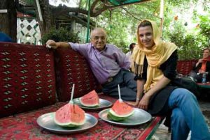 Enjoying watermelon with our woman guide and tour operator. 